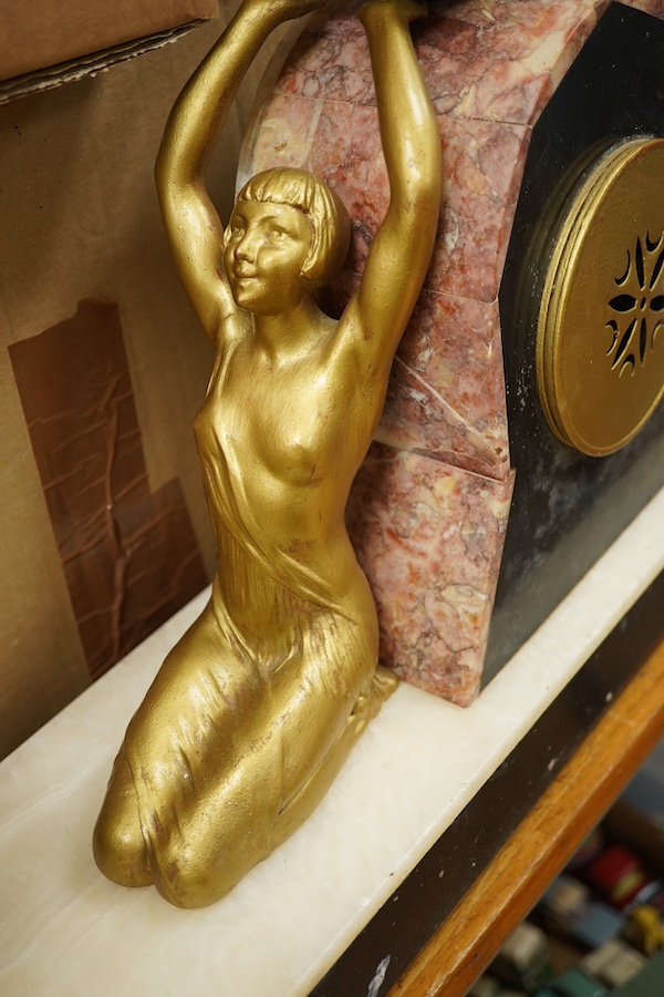 A French Art Deco figural and rouge marble clock garniture, 56cm wide. Condition - poor